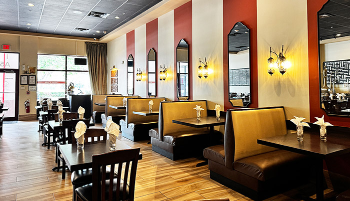 Leather booth seating by the front windows at Bombay Grove