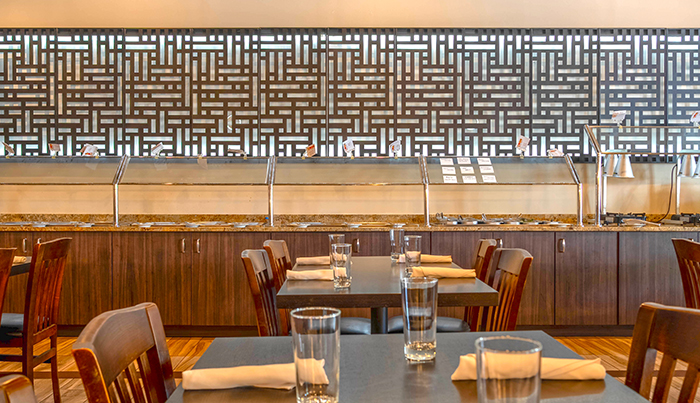Lunch buffet counter beneath the laser-cut screen at Bombay Grove