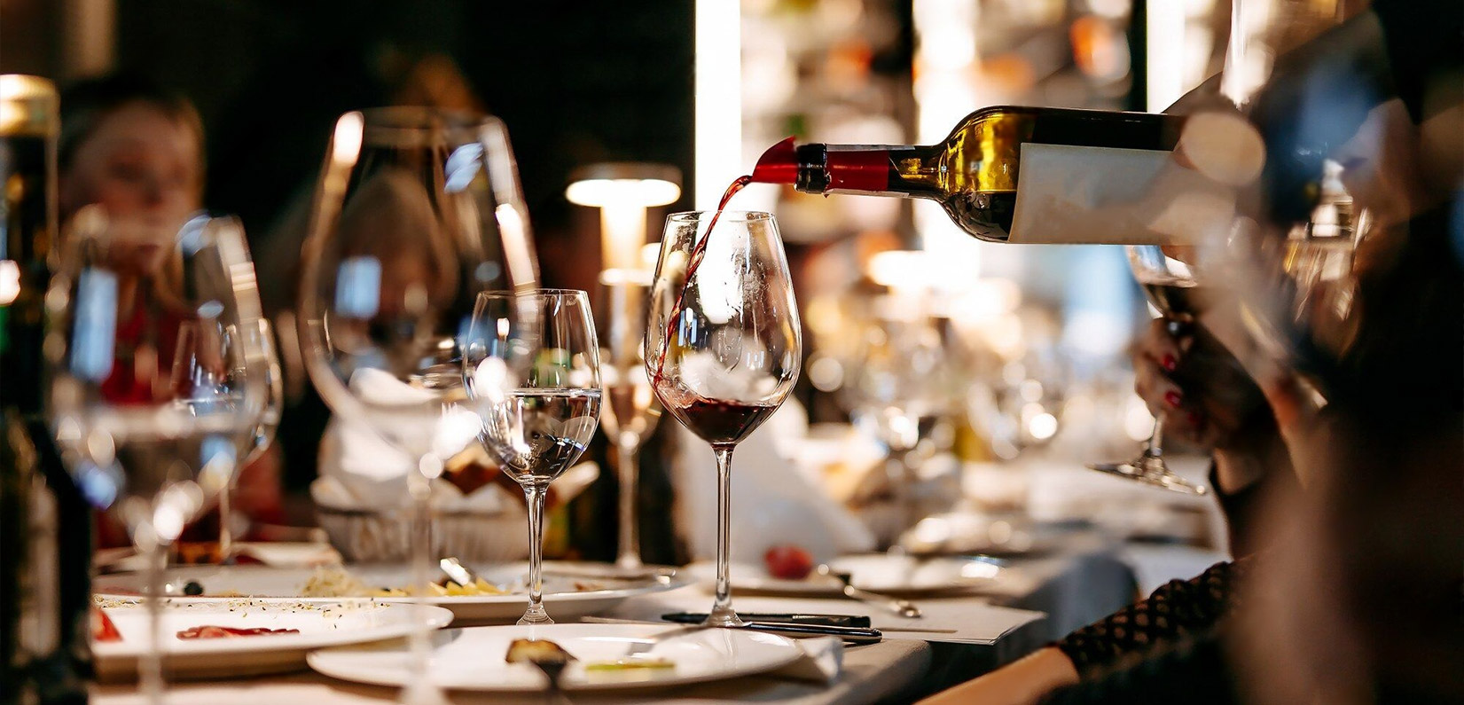 Red wine poured tableside during dinner service at Bombay Grove