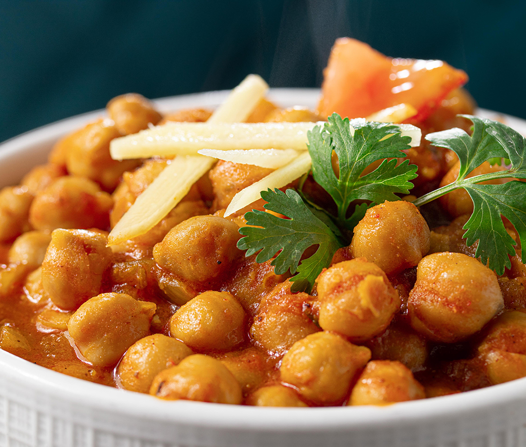 Chole masala — chickpea curry topped with ginger, tomato and cilantro
