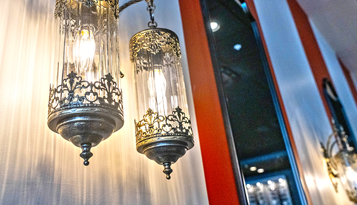 Ornate glass and brass pendant lights above the Bombay Grove dining room